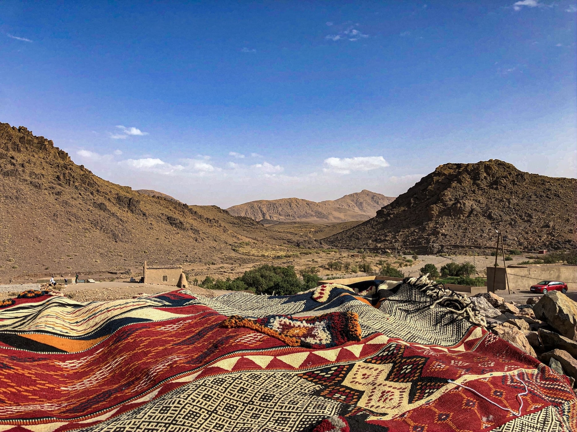 Moroccan rugs laid out in the Atlas Mountains near Essaouira, showcasing traditional patterns and handwoven craftsmanship