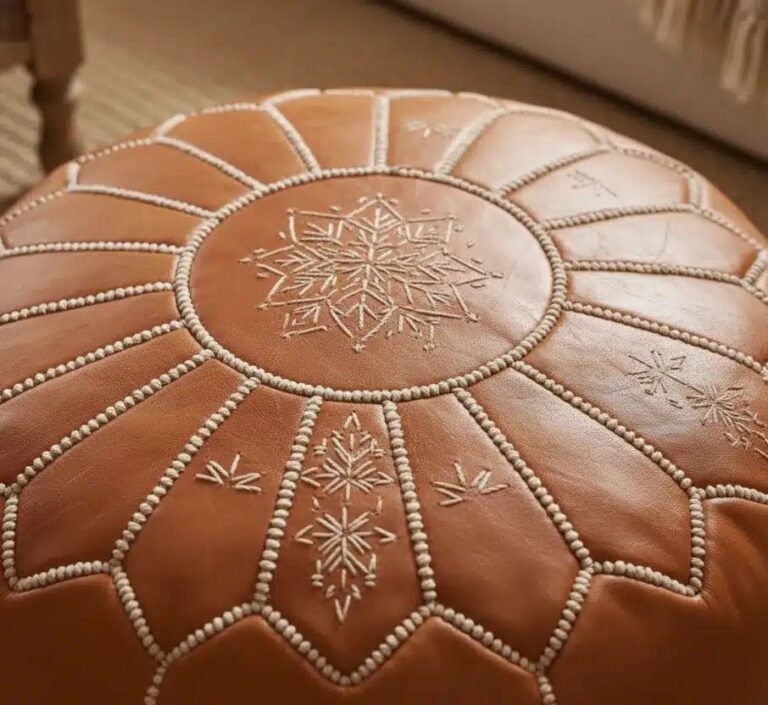 Authentic Moroccan leather pouf with hand-stitched geometric embroidery and natural leather grain